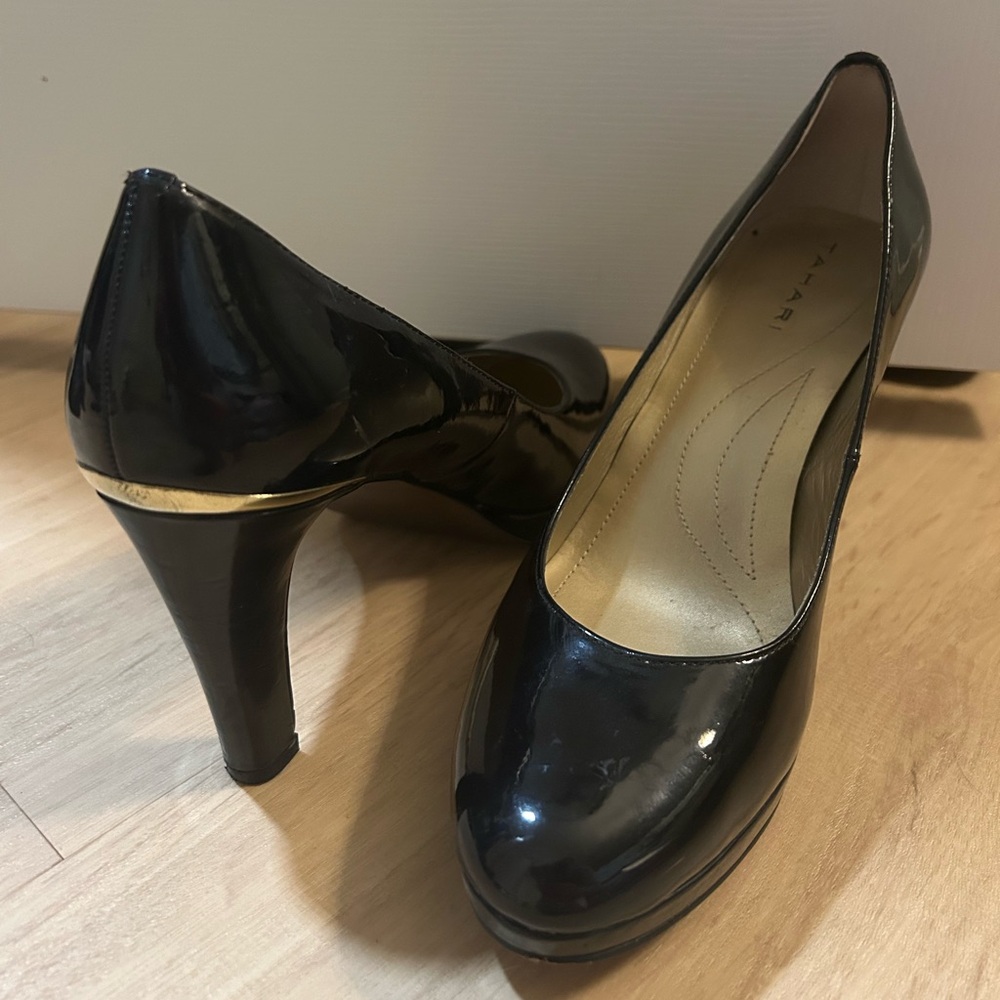 Beautiful black Tahari heels with gold accents and gold bottoms